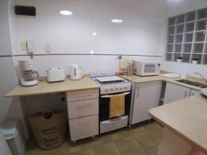 a kitchen with a stove top oven next to a counter at Recoleta - Fantástico departamento in Buenos Aires +26 photos