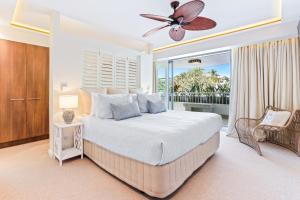 a bedroom with a large bed and a balcony at Beachfront luxury, Hastings Street in Noosa Heads