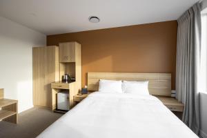 Postel nebo postele na pokoji v ubytování Manha Hotel Auckland Airport