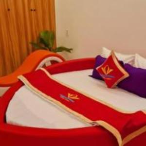 a red and white bed in a room at Happy 2 Hotel Bình Dương in Bến Cát