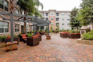a patio with couches and chairs in a courtyard at Houston Retreat 1 Bedroom 1 Bathroom NRG & Medical Center in Houston