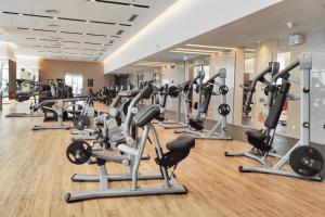 a gym with rows of exercise bikes and treadmills at Hyatt Regency Shenzhen Yantian in Shenzhen
