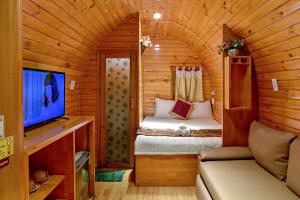 a small room with a bed in a wooden cabin at Mi Lan Villa Hotel in Vung Tau