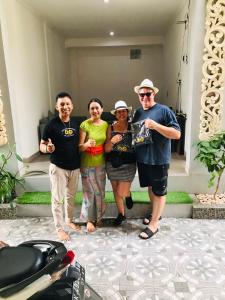 a group of people standing next to a motorcycle at Bali DD homestay seminyak in Seminyak