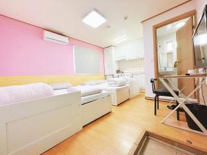 a hospital room with two beds and a mirror at Sarang Guesthouse Dongdaemun in Seoul