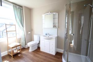 a bathroom with a toilet and a sink and a shower at The Sandaig in Edinburgh