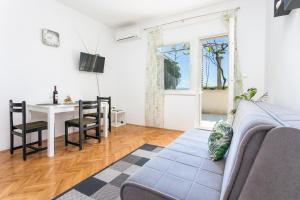 a living room with a couch and a table at Apartments by the sea Kastel Stafilic, Kastela - 21145 in Kaštela