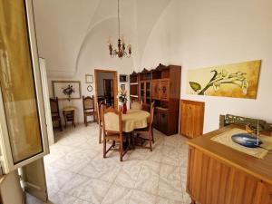 a kitchen and dining room with a table and chairs at Casa Galatea in Galatone