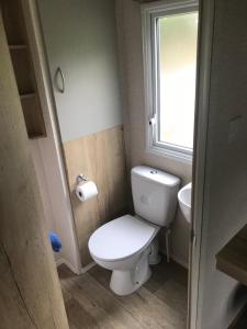 a small bathroom with a toilet and a window at Static stays in Longridge