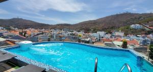 a large blue swimming pool on top of a building at Mi Lan Villa Hotel in Vung Tau