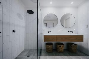 a bathroom with a sink and two mirrors at Park Crescent - Daylesford Macedon Region in Kyneton
