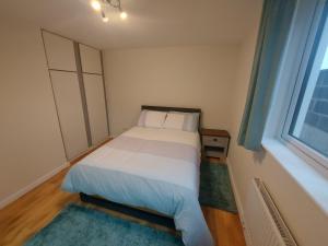 a small bedroom with a bed and a window at West coast countryside escape in Tuam