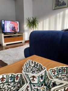 a living room with a table and a couch and a tv at Cozy and Modern Flat Near Bosphorus At Arnavutköy in Istanbul