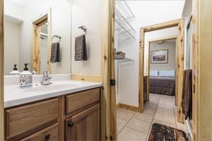 a bathroom with a sink and a mirror at The Lodge at Duck Creek in Duck Creek Village