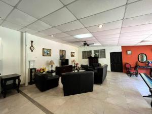 a living room with couches and chairs and a ceiling at San Diego Beach House, near La Lib and Surf City in La Libertad