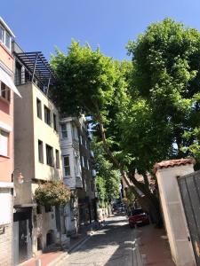 a street with a tree on the side of a building at Cozy and Modern Flat Near Bosphorus At Arnavutköy in Istanbul