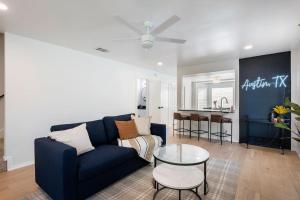 a living room with a blue couch and a table at 2 Bedroom East Riverside Home with Garage-Sleeps 6 in Austin