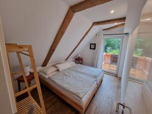 a bedroom with a bed and a ladder and a window at FeWo Monika in Schaprode