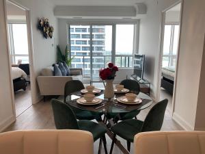 a living room with a table and chairs and a couch at QQ MARKHAM condo in Markham