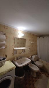 a bathroom with a toilet and a sink at Dominic Chania Center Apartment in Chania