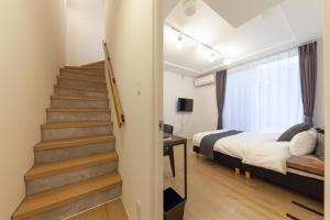 a bedroom with a staircase and a bed in a room at LEGALAND Gakushuin Shita in Tokyo