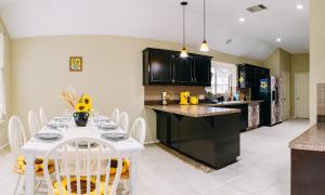 a kitchen with a white table and white chairs at Sunflower Ranch in Pflugerville