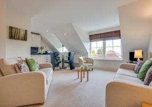a living room with two couches and a table at Glenhaven in Saundersfoot