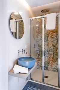 a bathroom with a blue sink and a shower at Casa Duca - Marina di Ragusa in Marina di Ragusa
