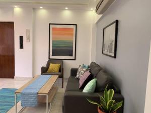 a living room with a couch and a table at Mon Desire 1, Perry Cross Rd, Bandra West by Connekt Homes in Mumbai