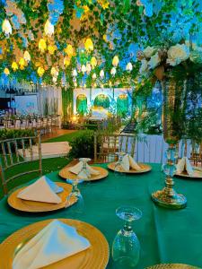 a table with plates and napkins on top at Hotel Carmelita in Tuguegarao City