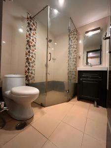 a bathroom with a toilet and a glass shower at Rio Classic, Top Rated & Most Awarded Property in Haridwar in Haridwār