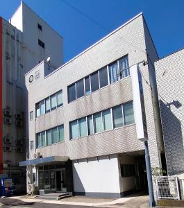 a large brick building on a city street at 令和院 Leiwa Inn in Tottori