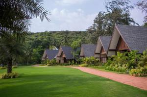 a row of houses with a green yard at W Goa in Vagator