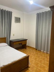 a bedroom with a bed and a desk in it at شقه in 6th Of October