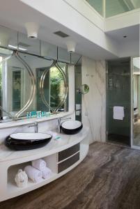 a bathroom with two sinks and a large mirror at W Goa in Vagator