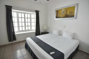 Säng eller sängar i ett rum på Tulipanes Cancun