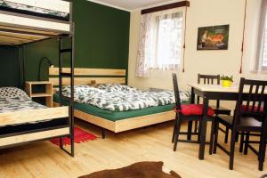 a bedroom with two bunk beds and a table at Glamping Hnačov in Hnačov +33 photos