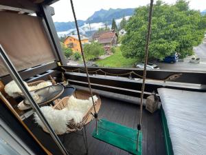 a boat with two swinging chairs and a window at Jollie‘s in Laax