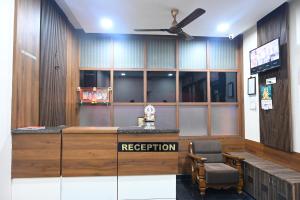 a reception desk in a room with a ceiling fan at KK SERVICE APARTMENTS in Vellore