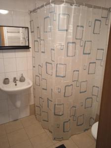 a bathroom with a shower curtain and a sink at Apartmán LauMar 2 in Bzenec