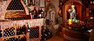 a room with a bunch of wine bottles on a wall at Hotel Restaurant Prechtlhof in Althofen