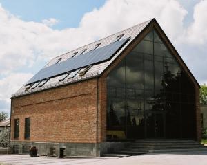 a building with solar panels on the roof at Szklany Przystanek in Kościerzyna