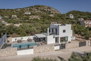 an image of a villa with a swimming pool at Avrilia Seaside Villa HEATED POOL in Almyrida