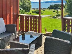 a patio with two chairs and a table on a deck at Two-Bedroom Holiday home in Storfosna in Sletta