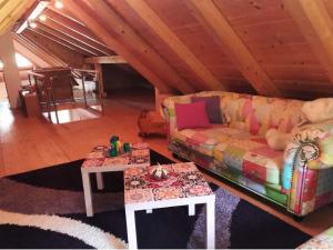 a living room with a couch and two tables at Holiday apartment near Lake Klopeiner with sauna in Neuhaus