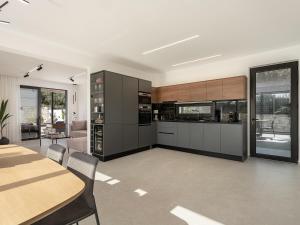 a kitchen with a table and a dining room at Avrilia Seaside Villa HEATED POOL in Almyrida