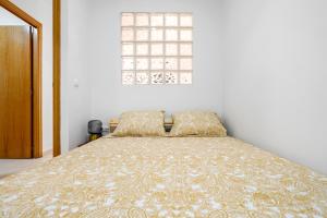 a bed in a white room with a window at Little Horse in Tarragona