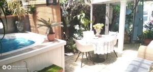 a patio with a table and a bath tub at Mitchell's Guesthouse in Parow