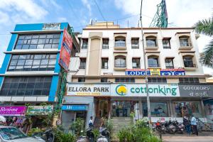 a building on a city street with motorcycles parked in front at Hotel Ellora Park in Pune