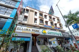 a large building with a sign for a store at Hotel Ellora Park in Pune